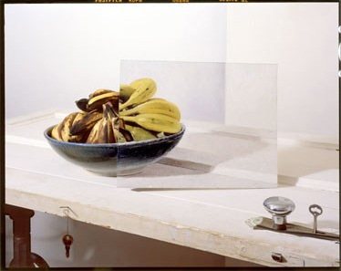 Bananas in bowl with painting on door 2012